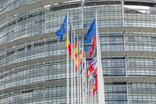 Strasbourg, France - July 18, 2018: All EU Flags European Union flag waving in front of European Parliament, headquarter of the European Commission European Parliament