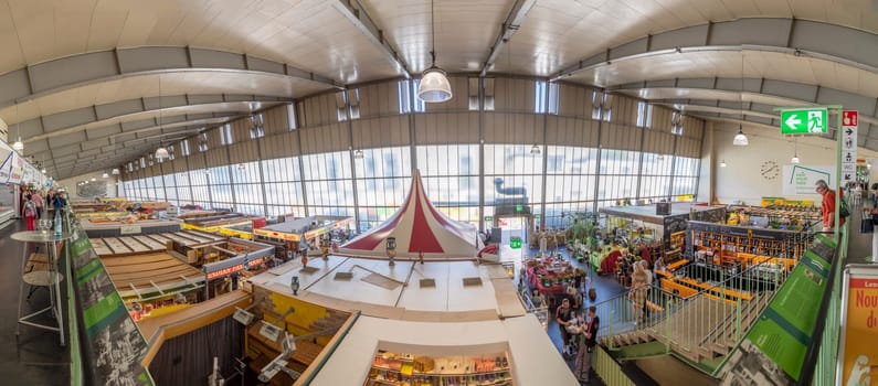 Frankfurt, Germany - July 19, 2018: people enjoy shopping in the Kleinmarkthalle in Frankfurt, Germany. The hall from 1954 is the most famous fresh food market in Frankfurt on 1500 SQ (m2).