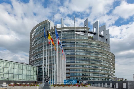 STRASBOURG, FRANCE - JUNE 18, 2018: modern architecture of european union parliament with flags of members in france, alsace, france