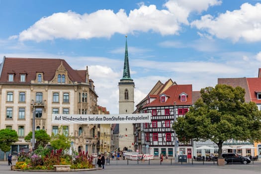 Erfurt, Germany - July 29, 2018: people at the dome square with banner Auf Wiedersehen bei den Domstufen Festspielen - engl: see again at next cathedral Festival.