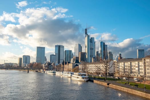 Frankfurt, Germany - January 14, 2019: skyline of Frankfurt am Main with ships on river Main.