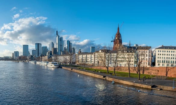 Frankfurt, Germany - January 14, 2019: skyline of Frankfurt am Main with ships on river Main.