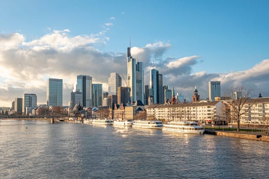 Frankfurt, Germany - January 14, 2019: skyline of Frankfurt am Main with ships on river Main.