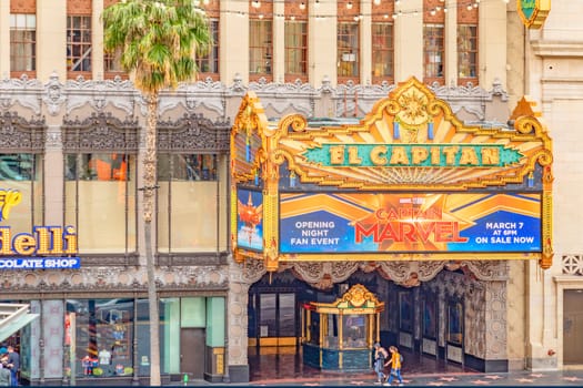 Los Angeles, USA - March 5, 2019: Hollywood and facade of famous cinema el Capitan and Chirardelli disney place by day.