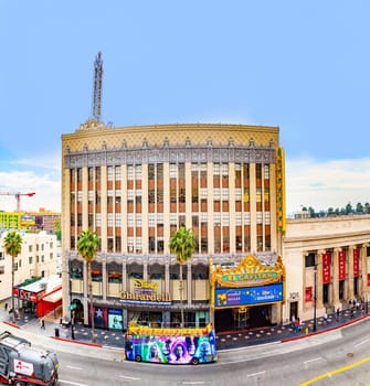 Los Angeles, USA - March 5, 2019: Hollywood and facade of famous cinema el Capitan and Chirardelli disney place by day.