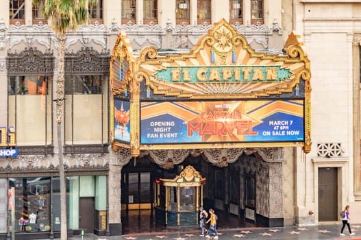 Los Angeles, USA - March 5, 2019: Hollywood and facade of famous cinema el Capitan and Chirardelli disney place by day.