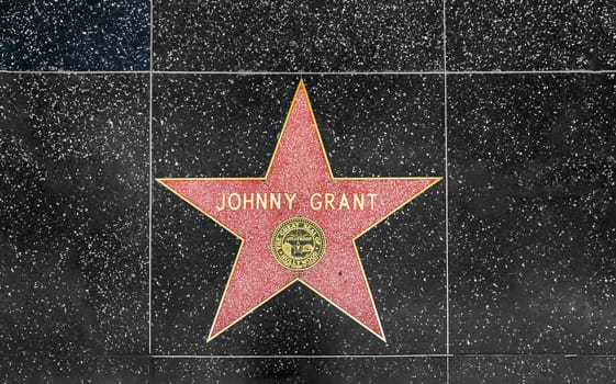 Los Angeles, USA - March 5, 2019: closeup of Star on the Hollywood Walk of Fame for Johnny Grant.