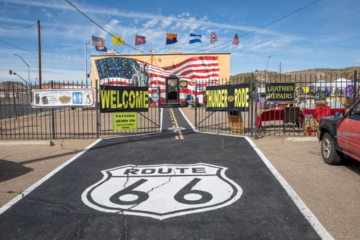 Flagstaff, USA - March 9, 2019: scenic view to shop selling Route 66 souvenirs and emblem from route 66 at bitumen floor.