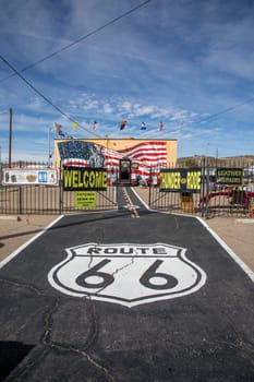 Flagstaff, USA - March 9, 2019: scenic view to shop selling Route 66 souvenirs and emblem from route 66 at bitumen floor.