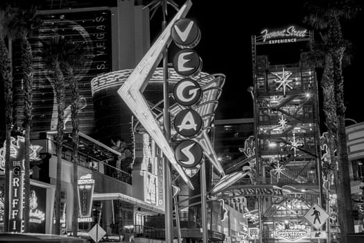 Las Vegas, USA - March 9, 2019: view to cowboy Vic in the Fremont street by night, illuminated by light bulbs  and entrance of Fremont street experience in Las Vegas, USA.