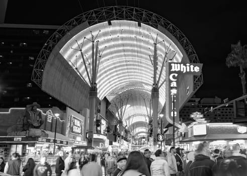 Las Vegas, USA - March 9, 2019: Fremont Street with many neon lights and tourists in downtown Las Vegas. It was the first paved street in Las Vegas in 1925.