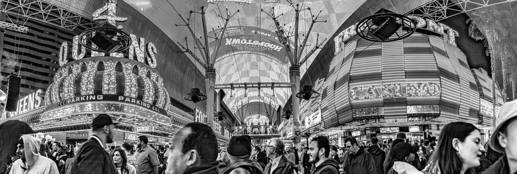 Las Vegas, USA - March 9, 2019: Fremont Street with many neon lights and tourists in downtown Las Vegas. It was the first paved street in Las Vegas in 1925.