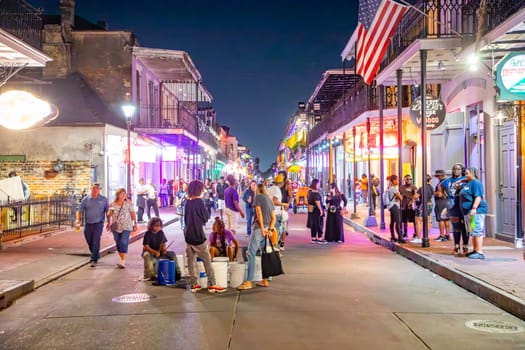 New Orleans  USA - October 24, 2023: people visit Pubs and bars with neon lights in the French Quarter, downtown New Orleans.