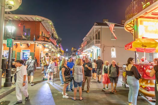 New Orleans  USA - October 24, 2023: people visit Pubs and bars with neon lights in the French Quarter, downtown New Orleans.