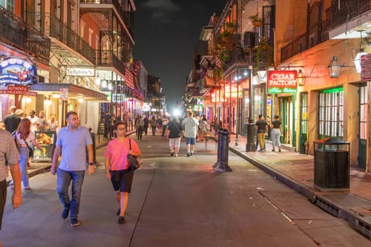 New Orleans  USA - October 24, 2023: people visit Pubs and bars with neon lights in the French Quarter, downtown New Orleans.