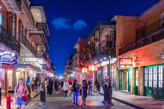 New Orleans  USA - October 25, 2023: people enjoy the clubs, musik, street life at the Bourbon street in the french quarter in New Orleans by night.