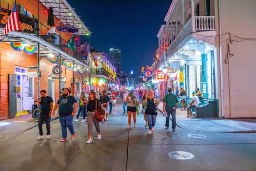 New Orleans  USA - October 25, 2023: people enjoy the clubs, musik, street life at the Bourbon street in the french quarter in New Orleans by night.