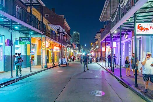 New Orleans  USA - October 25, 2023: people enjoy the clubs, musik, street life at the Bourbon street in the french quarter in New Orleans by night.