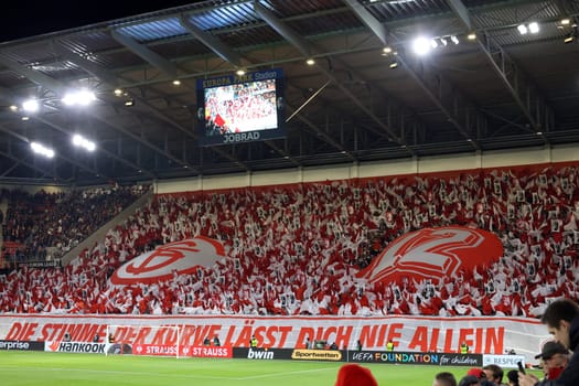 Successful choreography: The South Stand in red and white as the 12th man for the team at the match of the Football Europa League - Qualification 1/8 Final,SC Freiburg vs RC Lens
