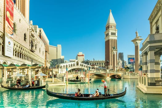 Las Vegas, USA - May 24, 2022: people enjoy a gondola ride at the Hotel and Casino The Venetian with singing gondolieres.