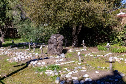 Carmel, USA - March 15, 2019: Grave sites of native Americans  - Indians - at the Carmel Mission are marked with stone circles and wooden crosses with abalone shells.