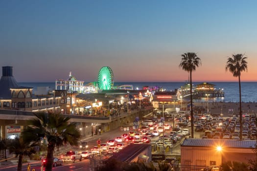 SANTA MONICA, USA - MAR 17, 2019: The  Santa Monica Pier in Santa Monica, USA by night. The site is an iconic 100-year-old landmark for California visitors.