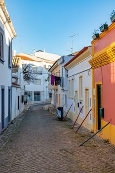 Lagos, Portugal - March 10, 2020: narrow road in old town of Lagos with colorful small historic fishermens houses.