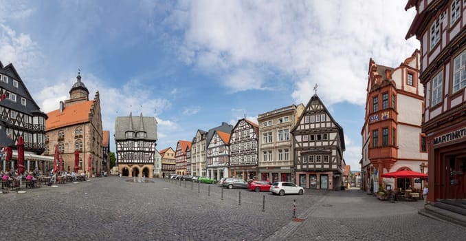 Alsfeld, Germany - June 25, 2021: famous town hall and half timbered historic houses at central square in Alsfeld, germany.