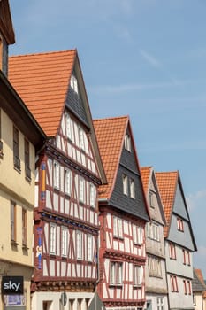 Alsfeld, Germany - June 25, 2021: famous town hall and half timbered historic houses at central square in Alsfeld, germany.