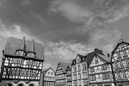 Alsfeld, Germany - June 25, 2021: famous town hall and half timbered historic houses at central square in Alsfeld, germany.