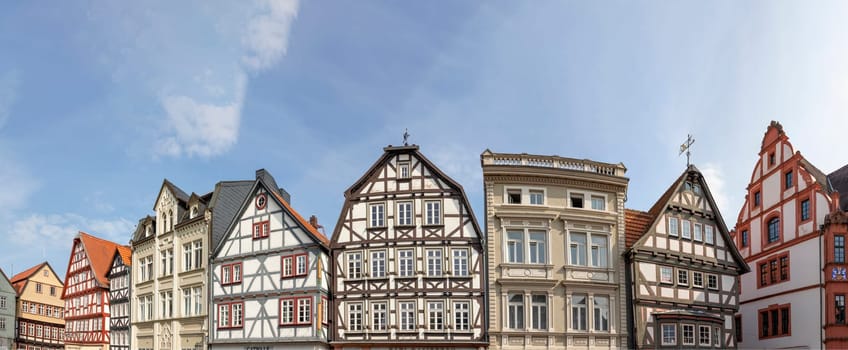 Alsfeld, Germany - June 25, 2021: famous town hall and half timbered historic houses at central square in Alsfeld, germany.