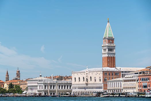Venice, Italy - July 1, 2021: view to promenade at St. Mark's square witd doges palace  in Venice, Italy under blue sky
