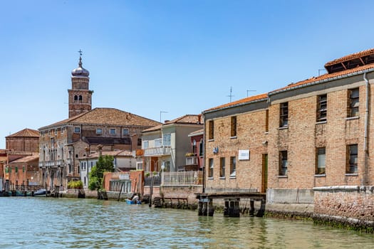 Murano, Italy - July 1, 2021: panoramic view to canal in Burano, the island of venice with historic glass blowing industry.