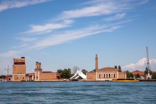 Venice, Italy - July 1, 2021: Lorenzo Quinn's Giant Stone Hands Represent Humanity’s Universal Values At Venice Art Biennale in Venice, Italy.