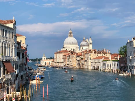 Venice, Italy - July 1, 2021: view to canale grande from bridge Academia in afternoon sun in Venice, Italy.