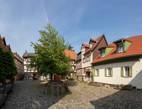 Alsfeld, Germany - June 25, 2021: famous town hall and half timbered historic houses at central square in Alsfeld, germany.