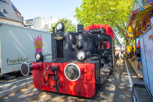 Frankfurt, Germany - July 18, 2021: old historic train operates in the Nizza area, the Main river promenade in Frankfurt.
