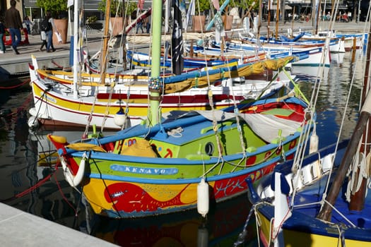 Sanary sur Mer, France - November 6, 2021: scenic view to harbor with colorful wooden fishermens boats  at Sanary sur Mer in France.