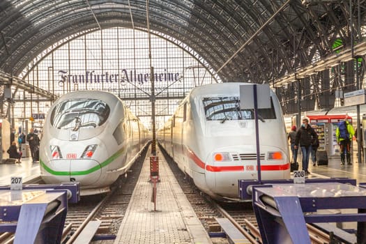 Frankfurt, Germany - December 22, 2021: people hurrying to the high speed train ICE at Frankfurt main station.