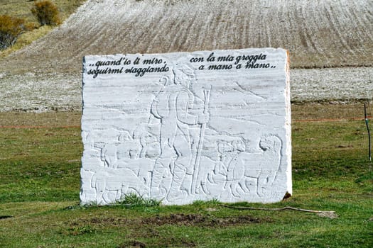 Castellugio, Italy - October 20, 2021: sculpture with poem of Leopardi  in the alpine region of Italy - phrases are from a song celebrating the night.