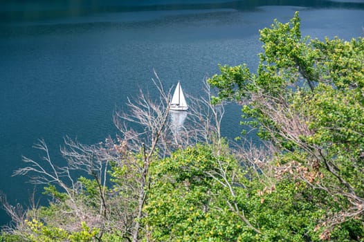 View of the Lake Eder with sky, sailboat and clouds, Hesse, Germany