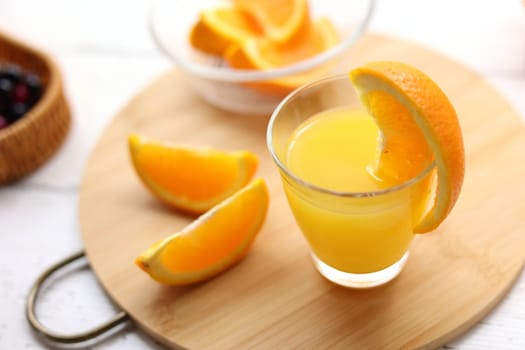 Fresh oranges and a glass of orange juice
