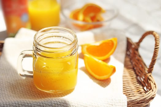 Orange juice poured into a mason jar mug cup