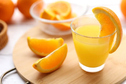 Fresh oranges and a glass of orange juice