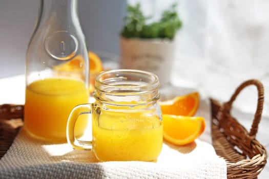 Orange juice poured into a mason jar mug cup