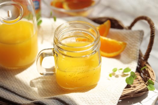 Orange juice poured into a mason jar mug cup