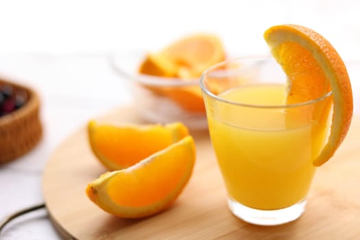 Fresh oranges and a glass of orange juice
