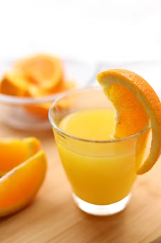 Fresh oranges and a glass of orange juice