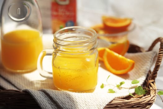 Orange juice poured into a mason jar mug cup