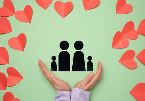 Two female hands and a drawn family, protection concept